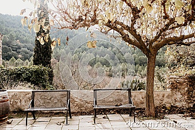 Two metal seats in a town square Stock Photo