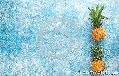 Two mini pineapples on a blue background Stock Photo