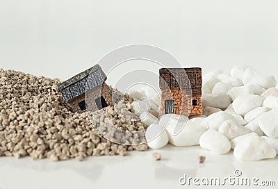 Two miniature houses in sand and rock isolated on white background with copy space Stock Photo