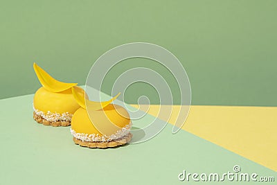 yellow-colored sweet treats set atop a blue and yellow-patterned tabletop Stock Photo