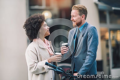 Two mixed race business people talking outside company Stock Photo