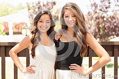 Two Mixed Race Teen Girlfriends Pose for Portrait Outdoors Stock Photo