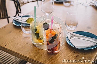 Two mojito cocktails made with aged rum, mint, and different fruits. Stock Photo