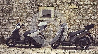 Two Mopeds in front of the Wall Stock Photo