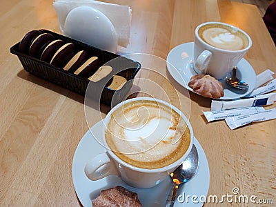 Two morning cups of cappuccino on the table. Stock Photo