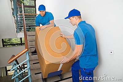 Two Movers With Box On Staircase Stock Photo