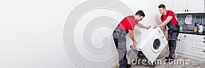 Two Movers Moving Appliance Stock Photo