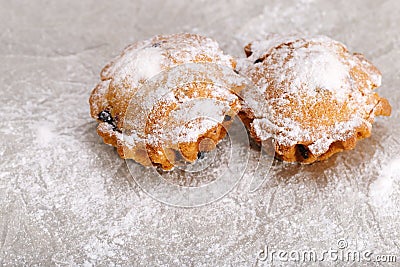 Two muffins sprinkled with powdered sugar. View from above. Copy space Stock Photo