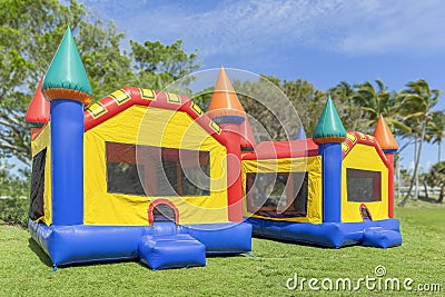 Two multi color castle bounce houses are ready for the kids Stock Photo