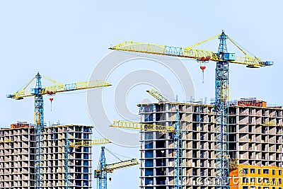 Two multi-storey buildings under construction. Many cranes. Construction of modern housing. Stock Photo