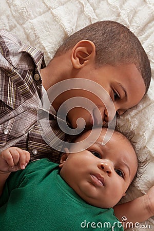 Two multiethnic boys brothers (focus on baby) Stock Photo