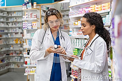 Two pharmacists working together at pharmacy Stock Photo