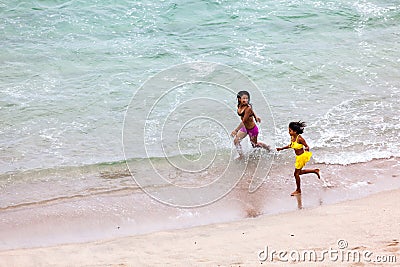 Two native girls run joyfully Editorial Stock Photo