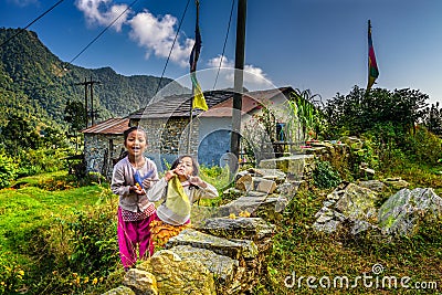 Two nepalese girls play in the garden of their home Editorial Stock Photo