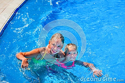 Two nice children girl swim in swimming pool. Stock Photo