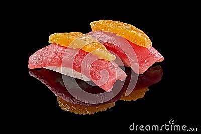 Two nigirizushi with tuna and orange on black background Stock Photo