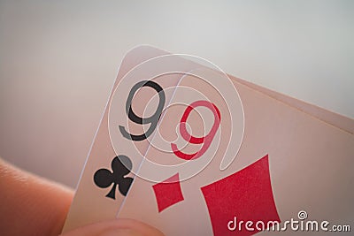 Two nines, Playing cards in hand on the table, poker nands Stock Photo