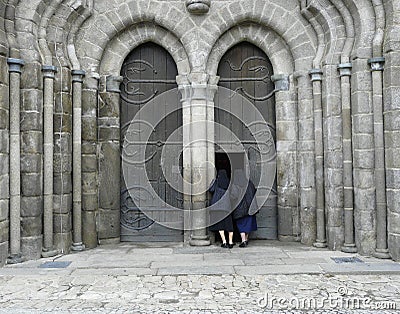 Two nuns looking into a church Stock Photo