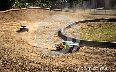 Two offroad RC cars racing on a track Stock Photo