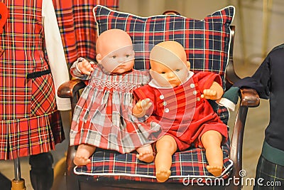 Old Fashioned Baby Dolls in Chair Stock Photo