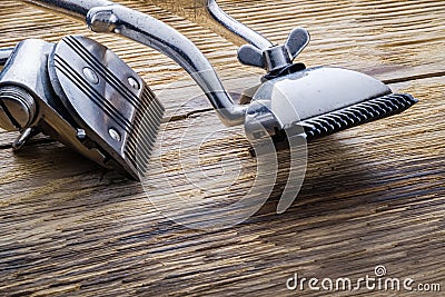 Two old manual haircut machine on old wooden scrached background. Stock Photo