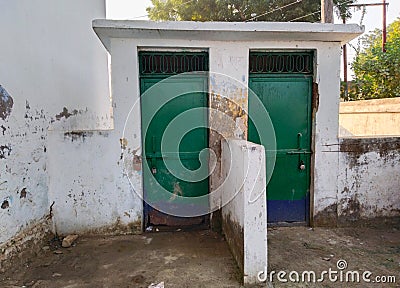 the two old outdoor toilets room, left door and right door. toilet door locked of government primary school, mostly student go Stock Photo