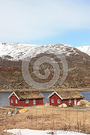 Two old traditional rorbu with grass on the roof Stock Photo