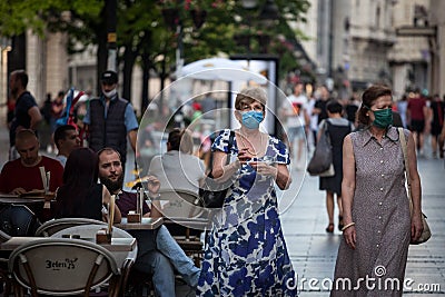 Two old Women, white caucasian females, walking wearing face mask respiration protective equipement on Coronavirus Covid 19 crisi Editorial Stock Photo