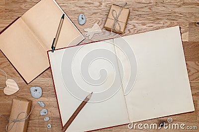 Two open books on the table. View from the top. Parcels or gifts associated with twine. The vintage style. Stock Photo