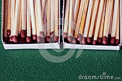 Many matches in paper boxes on a green surface Stock Photo