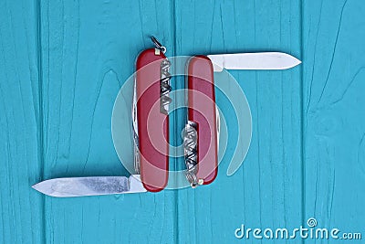 two open folding knives multitools with red handles with gray blades Stock Photo