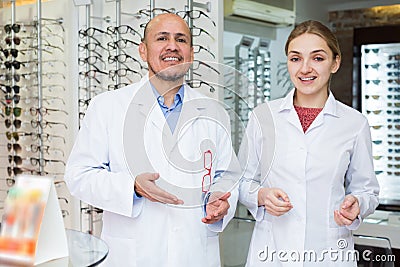 Two ophthalmologists working in optics store Stock Photo