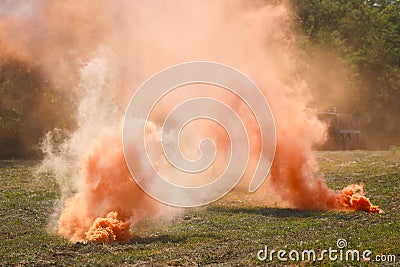 Two orange smoke grenades on the battlefield Stock Photo