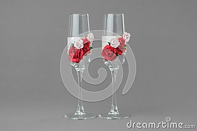 Two ornate wedding wine glasses decorated with red and pink roses. Stock Photo