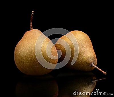 Two pair pears called manon isolated on black Stock Photo