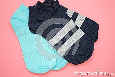 Two pairs of sports socks on a pink background top view. Stock Photo