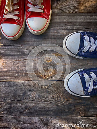 Two pairs of textile shoe on a gray wooden surface Stock Photo