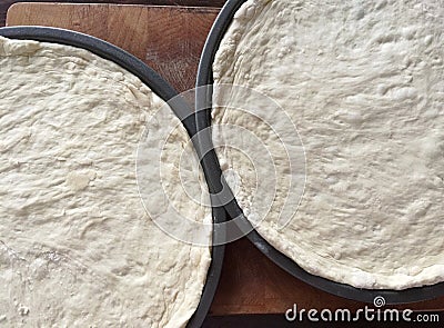 Two pans of raw pizza dough Stock Photo