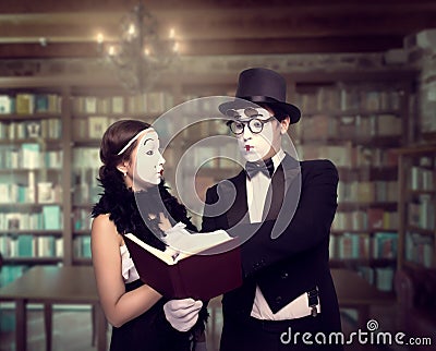 Two pantomime theater performers posing with book Stock Photo