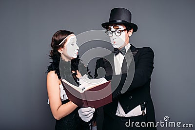 Two pantomime theater performers posing with book Stock Photo