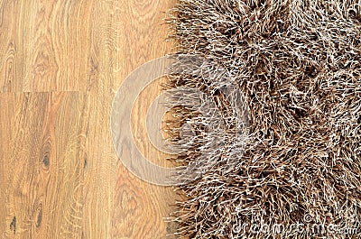 Two part split image of brown shaggy carpet and wooden floor Stock Photo