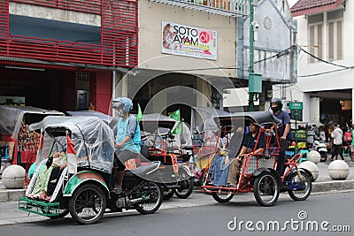 Two pedicab drivers were driving to find passengers Editorial Stock Photo