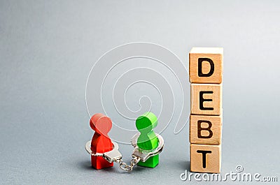 Two people are bound by handcuffs with the word Debt. Creditor and debtor. Financial slavery. Unclosed commitments. Blackmail and Stock Photo