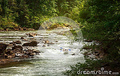 Two people drifting boat swift mountain river Stock Photo