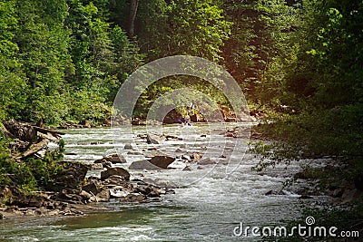 Two people drifting boat swift mountain river Editorial Stock Photo