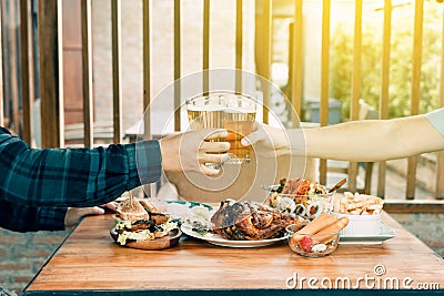 Two people drinking beer at restaurant. Stock Photo