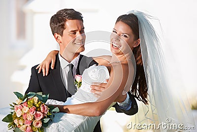 Two people happier would be impossible to find. Two newlyweds celebrating their marriage outdoors. Stock Photo