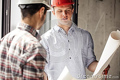 Two people having a degree of engineering with blueprint Stock Photo