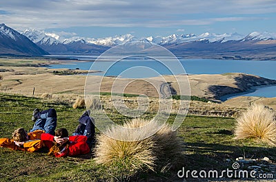 Two people laying and looking at Lake tekapo from Mount John observatory, South Island, New Zealand Editorial Stock Photo
