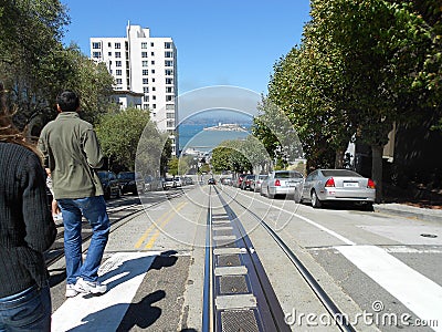 Two people look down the street in San Francisco Editorial Stock Photo